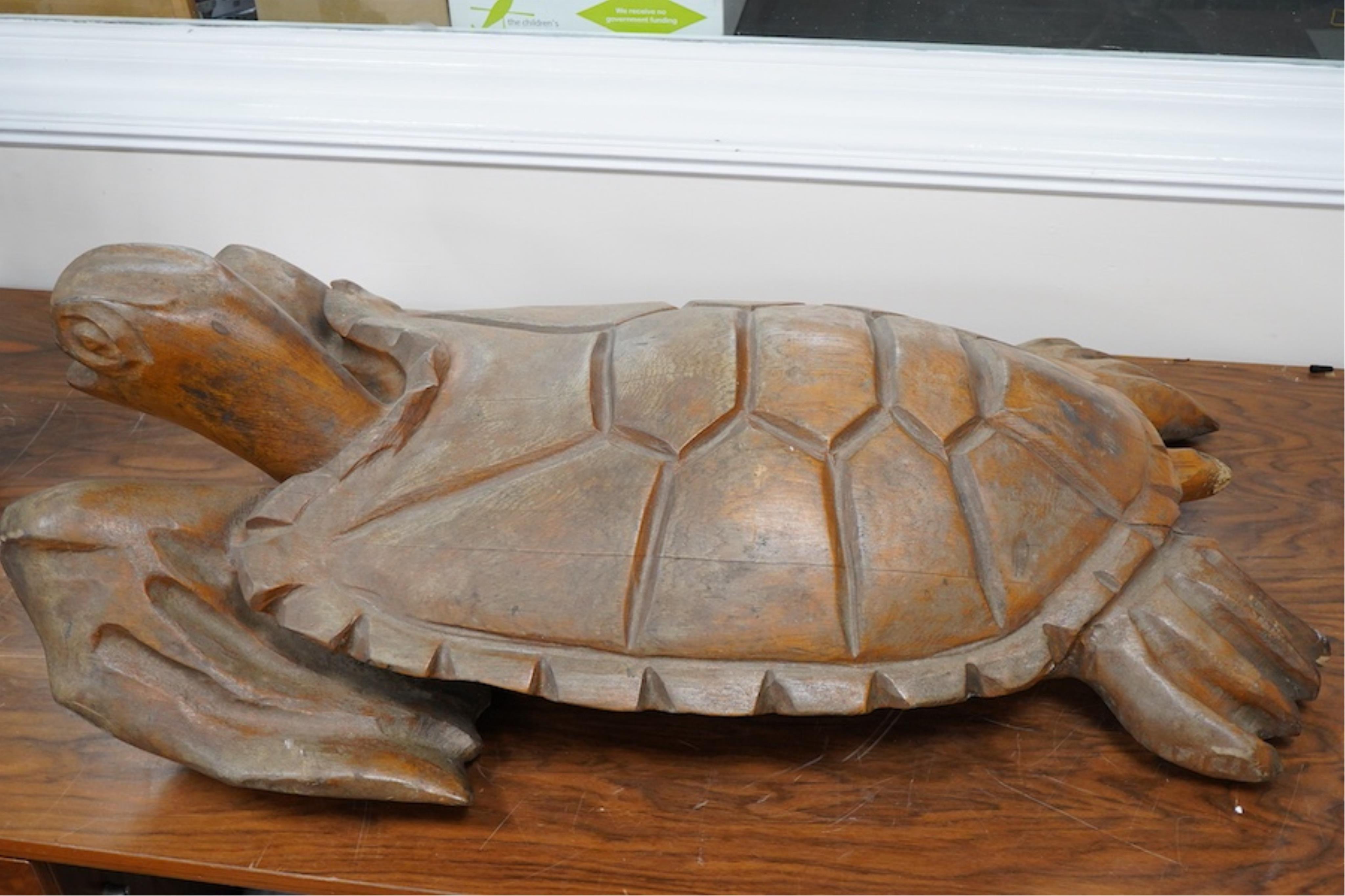 A large novelty carved weathered teak model of a green turtle